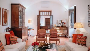 A living room with a sofa, two armchairs, a coffee table, and a cabinet. - Quinta do Bonfim - a historic refuge in the heart of Portalegre. (Portalegre)