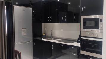 Family Apartment, Garden View | Private kitchen | Fridge, electric kettle, toaster, high chair