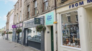 A street view with a dental clinic named 'Clear Water Dental' and a sign for 'Briggs & Hastings'.