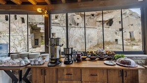 A kitchen with a coffee maker, kettle, and various dishes. - Rose Moon Cave (Nevşehir)