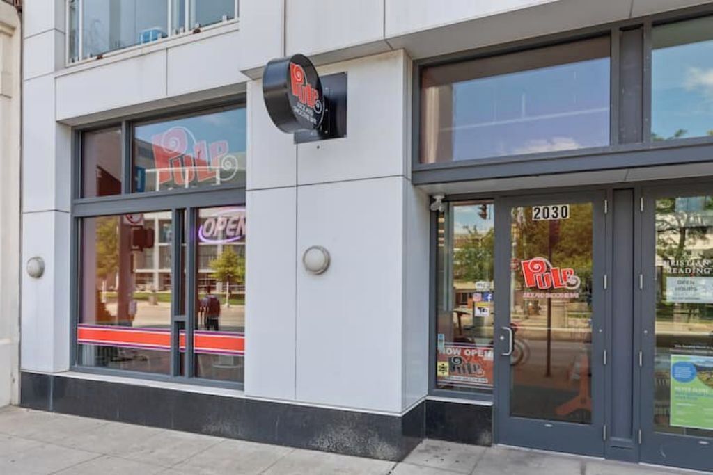 A building with a sign that reads "Pulp" and a door marked "2030".