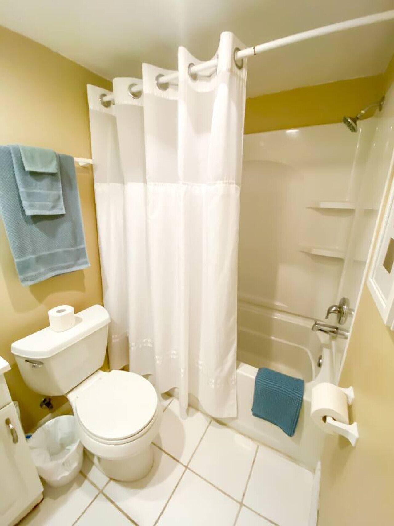 A bathroom with a toilet, a shower, and a bathtub.