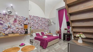 A bedroom with a bed, bedside table, and a chair.
