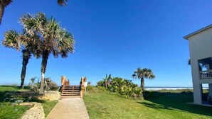 A pathway leading to a building with a view of the ocean. - Perfect located ocean front efficiency. (St. Augustine)