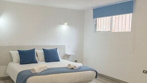 A bedroom with a bed, a nightstand, a window with blinds, and a ceiling light fixture. - House With Private Terrace, Sunsets and Barbeque (Arona)
