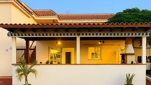 A two-story building with a tiled roof, a balcony, and a small porch area. - House With Private Terrace, Sunsets and Barbeque (Arona)