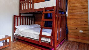 A bunk bed room with wooden floors and a ceiling fan. - A 3-bedroom villa in beautiful San Francisco De Macoris with amenities and more (San Francisco De Macoris)
