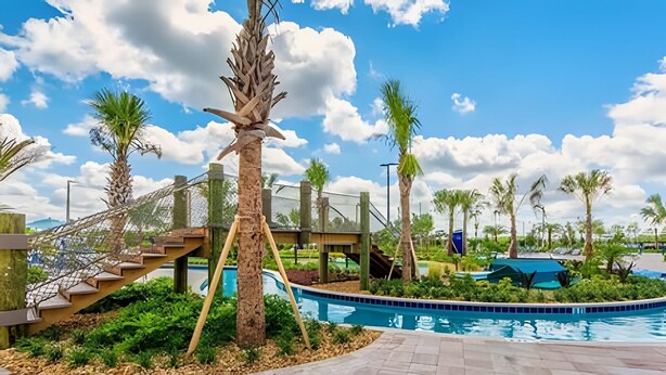 A pool area with a palm tree, a wooden staircase, and a clear blue sky. - 6BR Townhome w/ Pool – 10 Min to Disney (Kissimmee)
