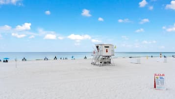 A lifeguard tower on a beach with clear skies.