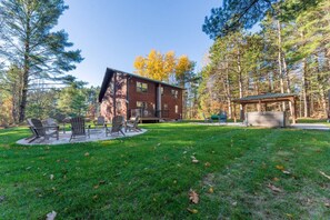 A cabin with a deck, outdoor seating, and a covered area. - Kavanagh Bay Resort|Hot Tub&Sauna #1 (Hayward)