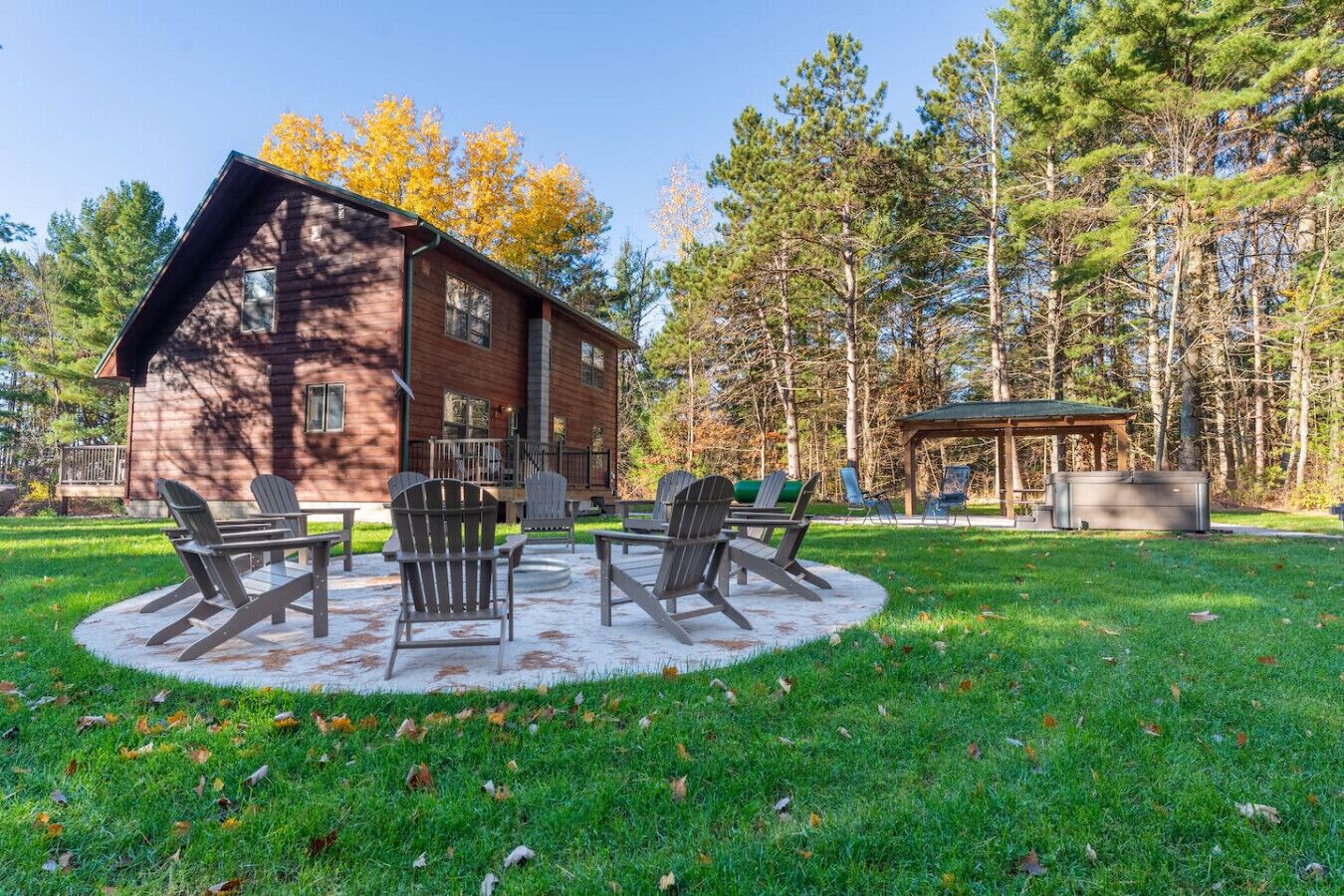 A rustic cabin with a deck and outdoor seating area.