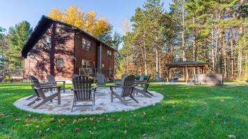 A rustic cabin with a deck and outdoor seating area.