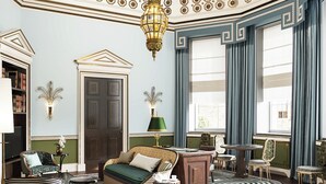 A room with a sofa, a desk, a chair, a lamp, and a bookshelf. - Cambridge House, Auberge Collection (London)