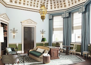 A room with a sofa, a desk, a chair, a lamp, and a bookshelf. - Cambridge House, Auberge Collection (London)