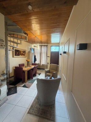 A living room with a dining area, a staircase, and a view of the outdoors. - Vacation Home in Tubize (TUBIZE)