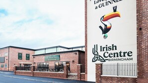 A brick building with a sign for the Irish Centre Birmingham and a Guinness advertisement. - Pairc House Hotel (Birmingham)