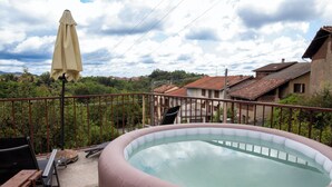 A swimming pool with a metal railing, a lounge chair, and an umbrella. - Ca' Dij Noni (Valle San Nicolao)