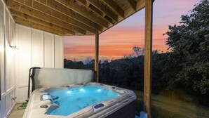 A hot tub with a control panel, set against a backdrop of a sunset and trees. - Sleeps 10, HotTub, Game Room, Views, Pet Friendly (Sevierville)