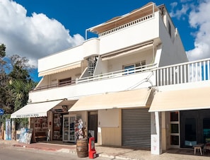 A two-story building with a ground-floor shop and upper residential units. - Casa Onda Blu Fronte Mare nel Cuore di Torre Lapillo (Porto Cesareo)
