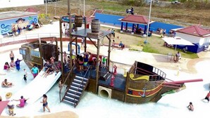 A water park with a pirate-themed play structure, including slides and a ship-shaped pool. - Luxury stay at a budget friendly cost (San José)