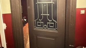 A dark wooden door with intricate geometric patterns and a central vertical design. - la rambla guest house 2025 (Barcelona)