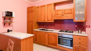 A kitchen with wooden cabinets, a microwave, a stove, and a dishwasher.
