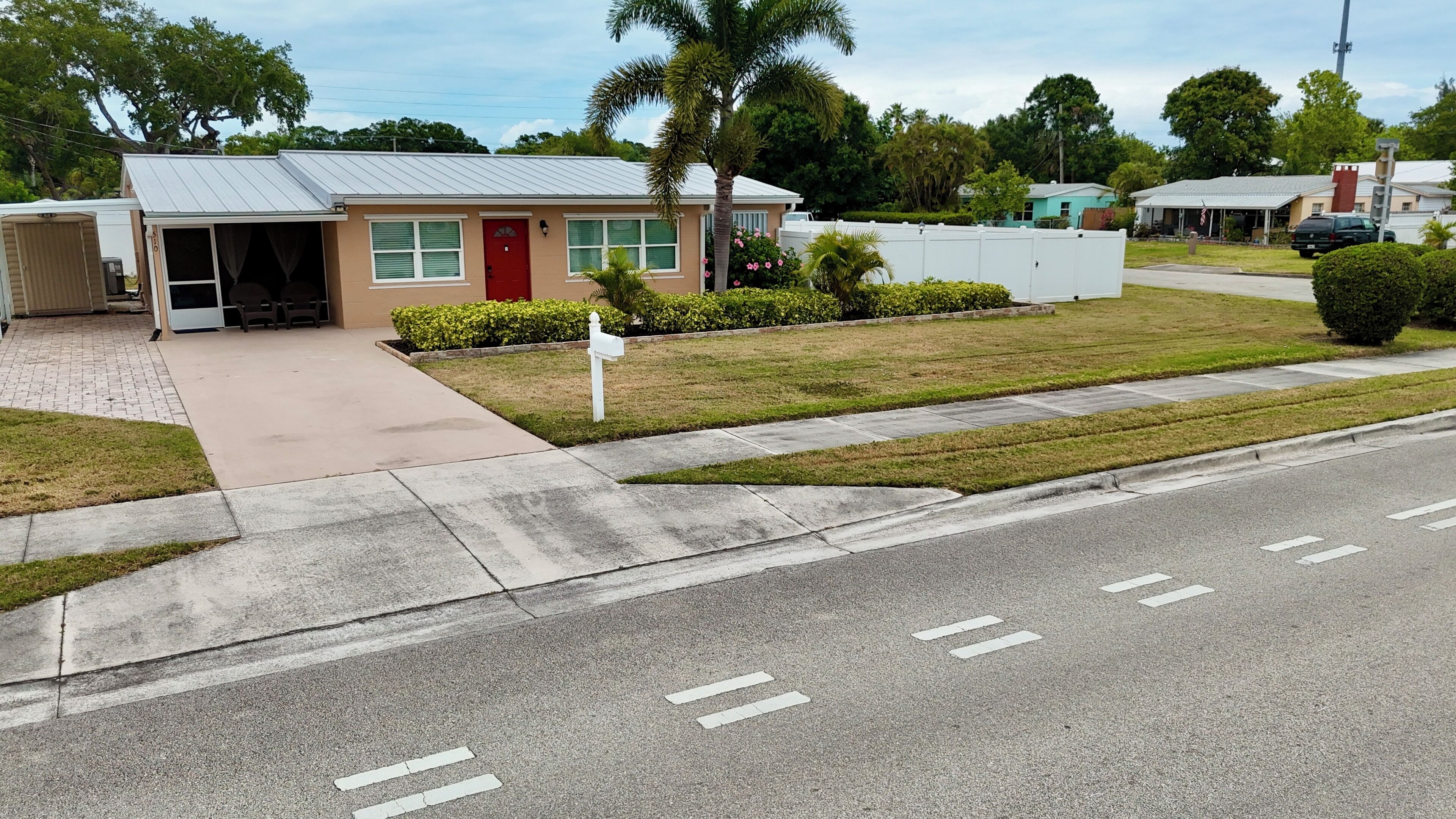 A single-story building with a red door and a covered porch.