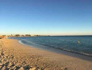 A beach with a sandy shore and calm water. - Casa Porto Beach Vacanza al Mare nel Cuore di Porto Cesareo (Porto Cesareo)