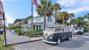 A beach house with a VW camper parked in front, a stop sign, and an American flag. - Walk 2 Private Beach, Private Pool, Bikes, Grayton (Santa Rosa Beach)