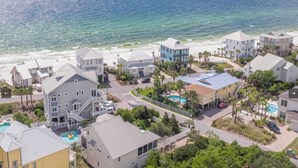 A coastal residential area with multiple two-story houses, a swimming pool, and a beach in the background. - Walk 2 Private Beach, Private Pool, Bikes, Grayton (Santa Rosa Beach)