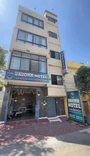 A multi-story building with a sign for 'Jajora Hotel' indicating A/C rooms available for stay. - Jajora Udaipur By Premier Hotels (Udaipur)