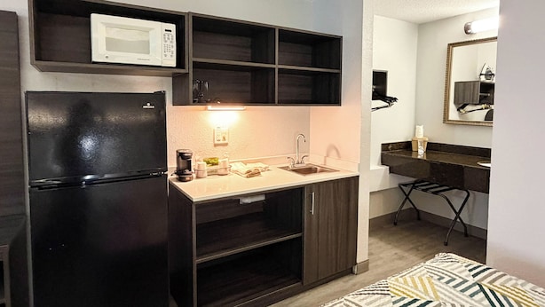 A compact kitchen with a refrigerator, microwave, coffee maker, and sink. - Studio 6 - Stafford, Va - Quantico (Stafford)