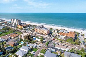 An aerial view of a coastal city with a beach, buildings, and roads. - Bright and recently redone condo hot tub pool and tennis direct beach access (Indian Rocks Beach)