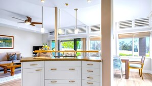 A modern kitchen with white cabinetry, a wooden countertop, and pendant lighting. - NEW! KBM Resorts: Kapalua Ridge Villas KRV-2314 Sweeping Ocean, Golf/Mountain Views, w/Rental Car (Lahaina)