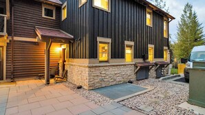 Une maison à deux étages, avec des fondations en pierre et un revêtement en bois.