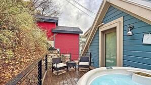 A wooden deck with two wicker chairs and a hot tub. - A romantic getaway that's steps from Main Street. (Park City)