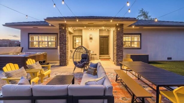 An outdoor patio area with seating, a fire pit, and string lights. - Game room+Hot tub+Mtn views+Parking+Kid-friendly (Moab)