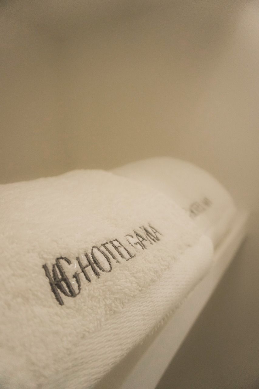 A white towel with embroidered text.