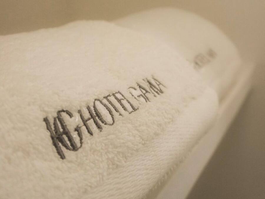 A white towel with embroidered text.