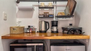 A compact kitchenette with a microwave, coffee maker, and a small refrigerator. - Eco Suite 1-bedroom villa in awesome La Fortuna with AC (La Fortuna)