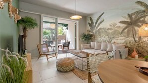 A spacious living room with a sofa, chairs, a coffee table, and a dining area. - Maison GAMA, 2 bedrooms and shared pool (CISTERN!!!) (Collectivity of Saint Martin)