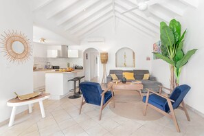 A modern interior with a kitchen, dining area, and living room.