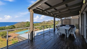 A covered outdoor area with a pool, seating, and a view of the ocean. - Simbithi Coastal Escape | Luxury with Ocean Views (Dolphin Coast)