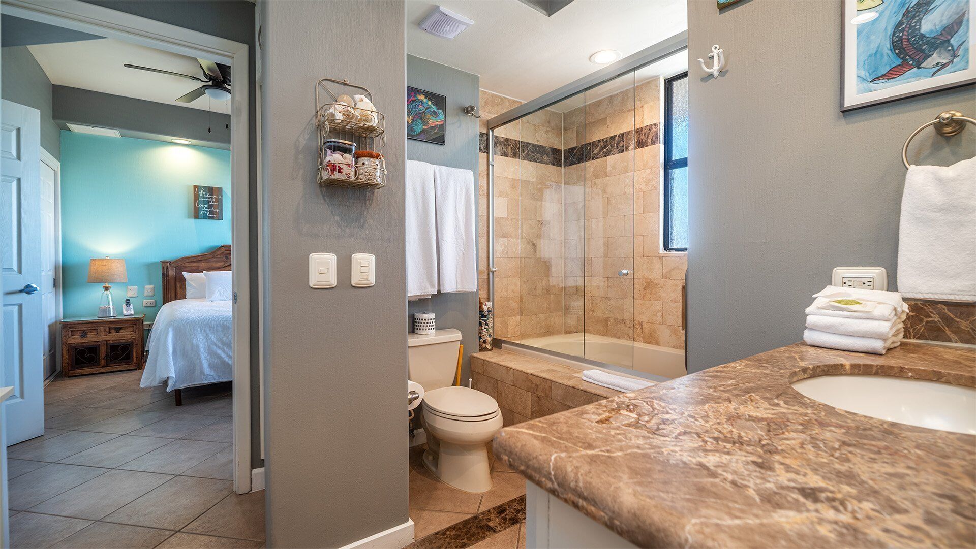 A modern bathroom with a shower, toilet, and sink.
