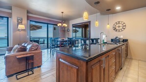 A modern kitchen with a large island, a dining area with a view, and a cozy seating area with a view. - Las Palomas Beach and Golf Resort (Puerto Peñasco)