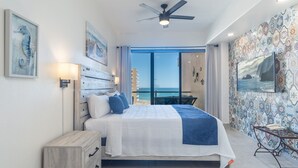 A bedroom with a bed, a nightstand, a ceiling fan, and a view of the ocean. - Las Palomas Beach and Golf Resort (Puerto Peñasco)