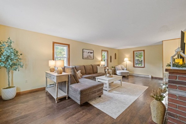 Bright, spacious living area with large windows and comfortable seating.