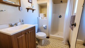 A bathroom with a sink, toilet, and shower. - Elk Haven Cabins - Cabin 2 (Payson)