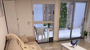 A living room with a sofa, a coffee table, and a decorative peacock statue.