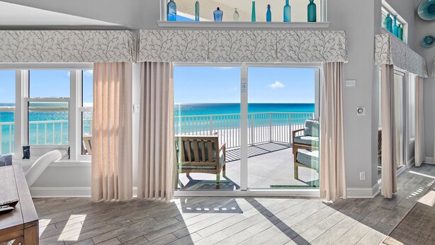 A spacious room with a large sliding glass door leading to a balcony with a view of the ocean. - Cabana Club C408- Sugar Sand Shores (Destin)